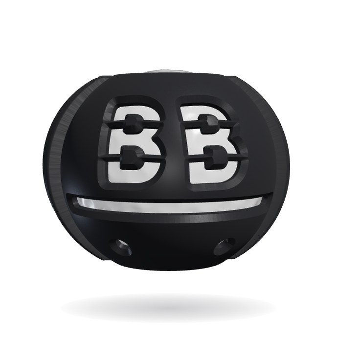 The Ball Buddy golf ball stencil and line marker in black nylon, clipped onto a golf ball with the initials BB, a line and two dots cut through it
