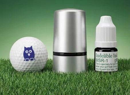 Metal golf ball stamp, shown with example designs